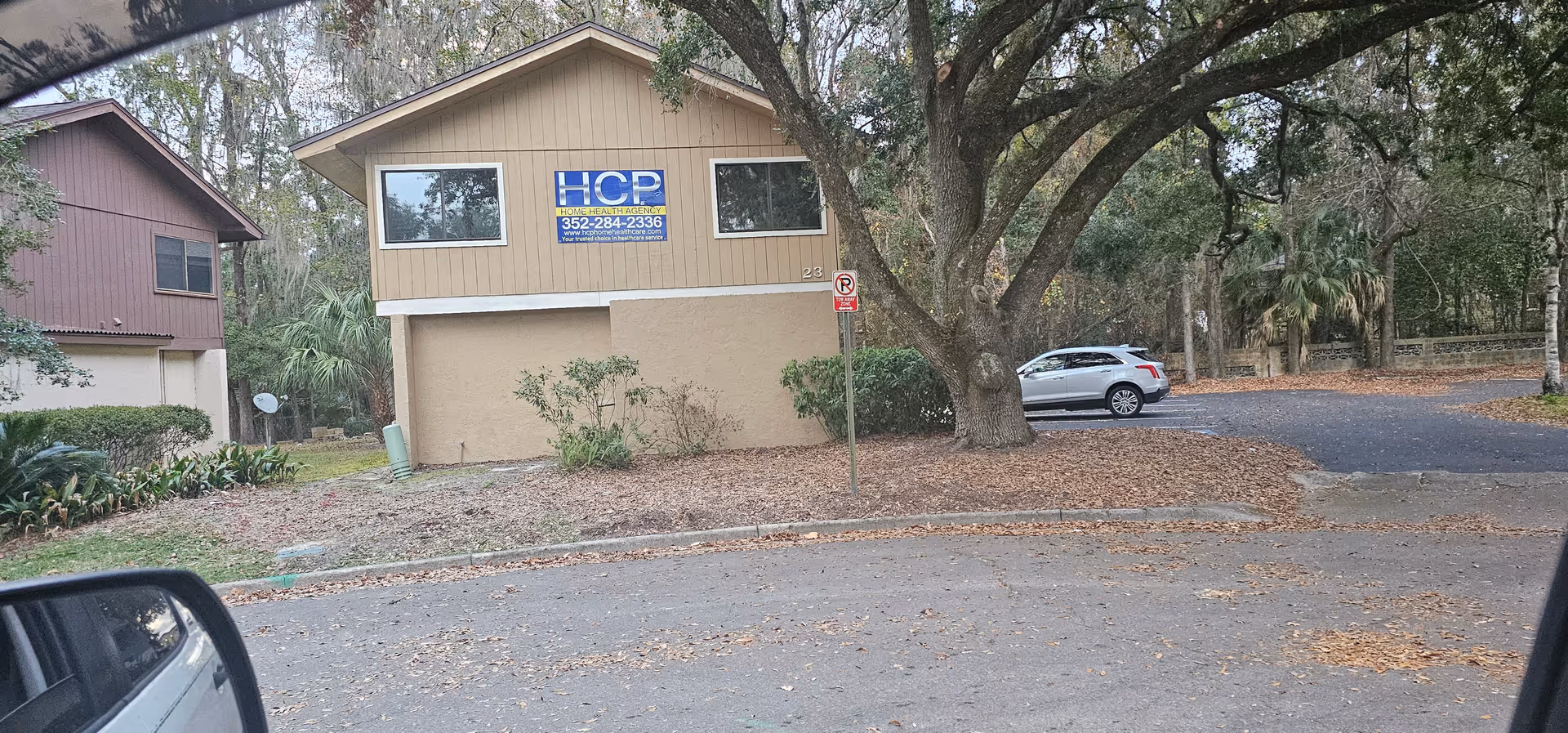 Exterior view of an HCP Home Healthcare Agency building with a parking lot.