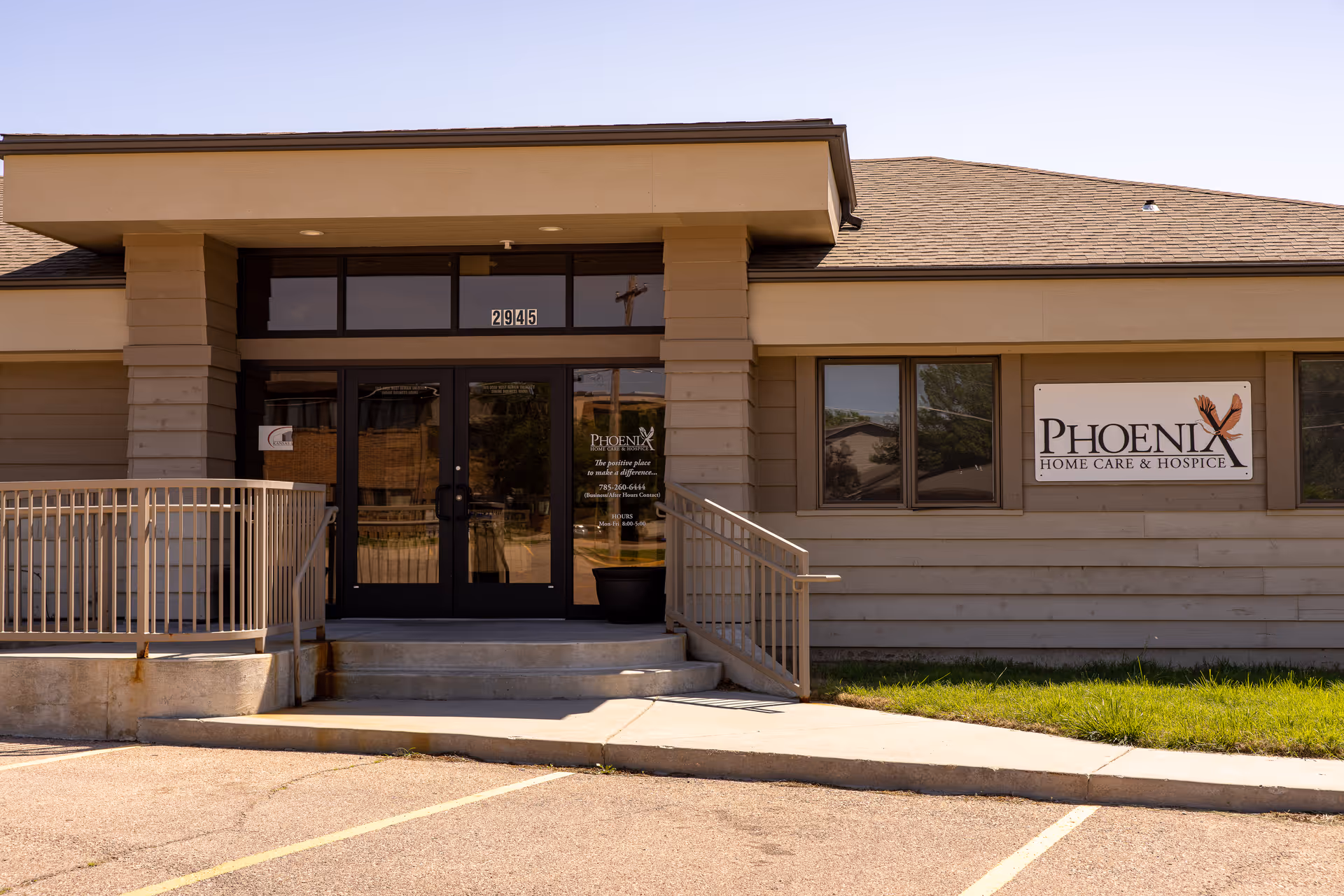 Exterior view of a Phoenix Home Care and Hospice entrance with a sign on the wall.