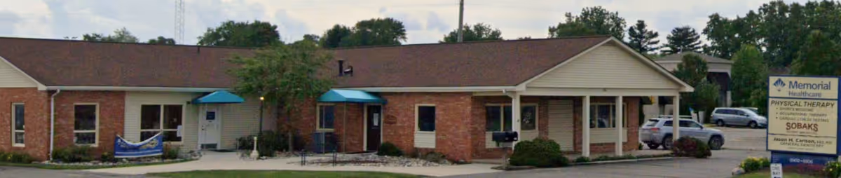 Exterior of Sobaks Home Medical, Inc. building with blue awnings and a parking lot.