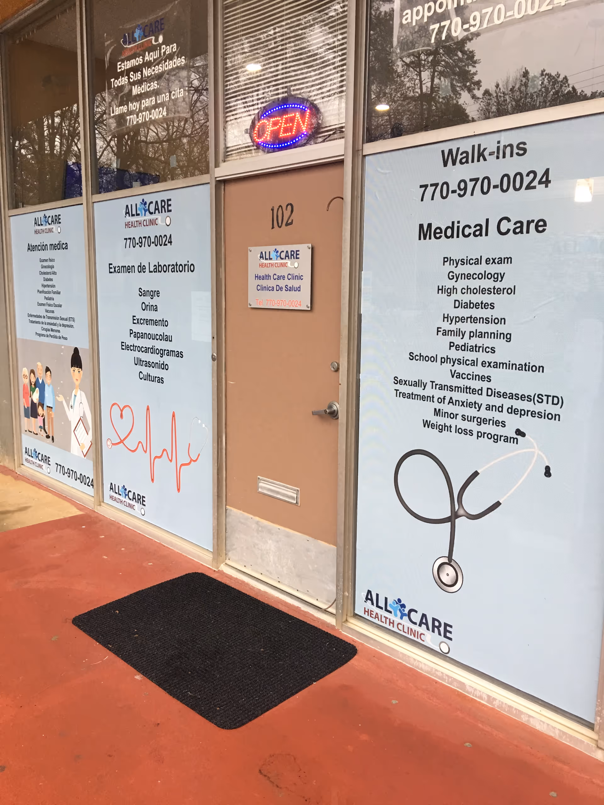 Exterior storefront of Allcare Health Clinic with door 102 and an open sign.