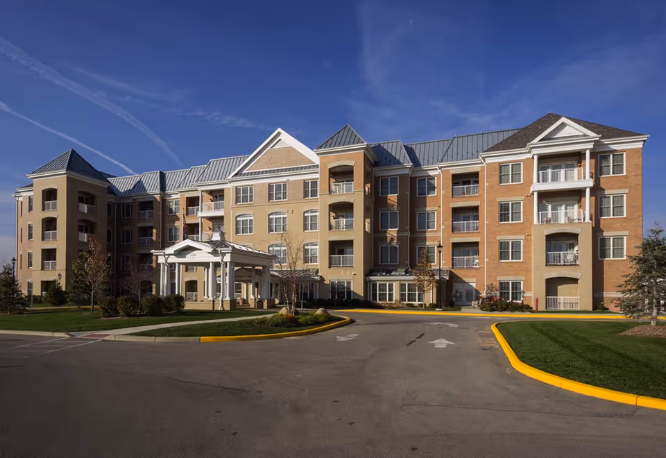 Exterior view of Sunrise on Old Meridian, a brick senior living building with a circular drive.