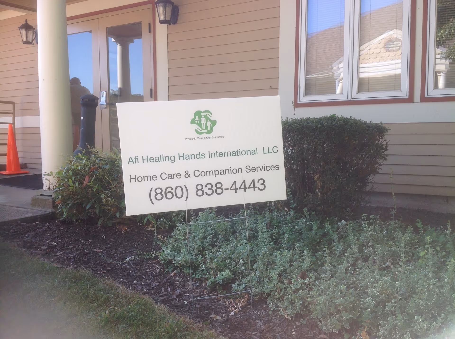 Exterior view of a building with a sign for Afi Healing Hands International LLC.