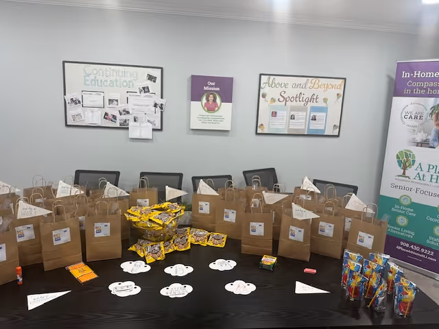 Conference room with brown paper gift bags arranged across a long dark table.