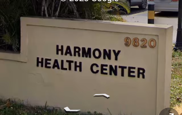 Exterior sign for Harmony Health Center displaying 9820.