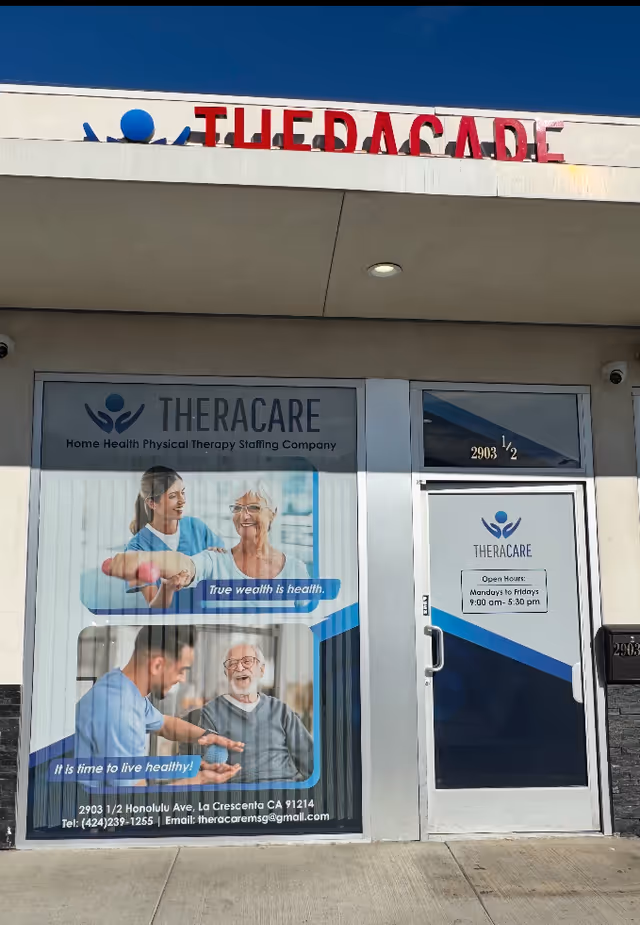 Exterior TheraCare storefront with a large poster window and glass entrance door.
