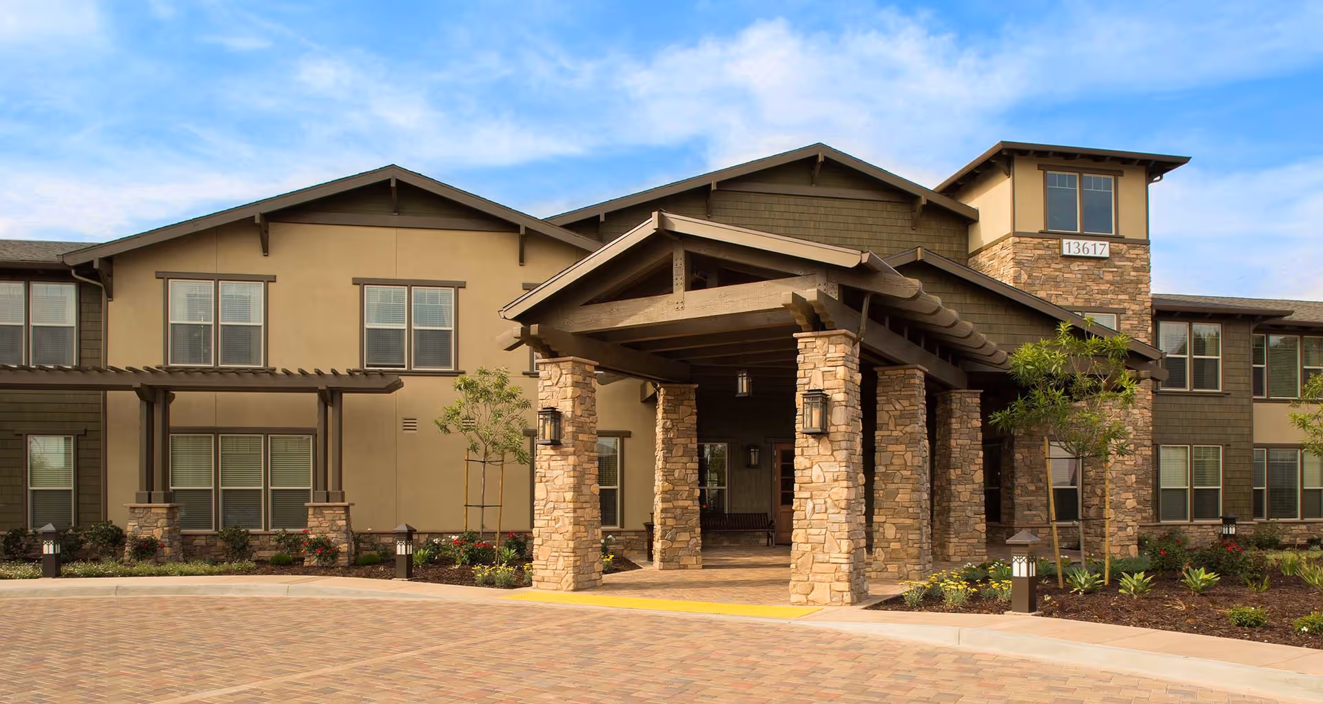 Exterior view of Oakmont of Whittier building with stone columns and covered entrance.