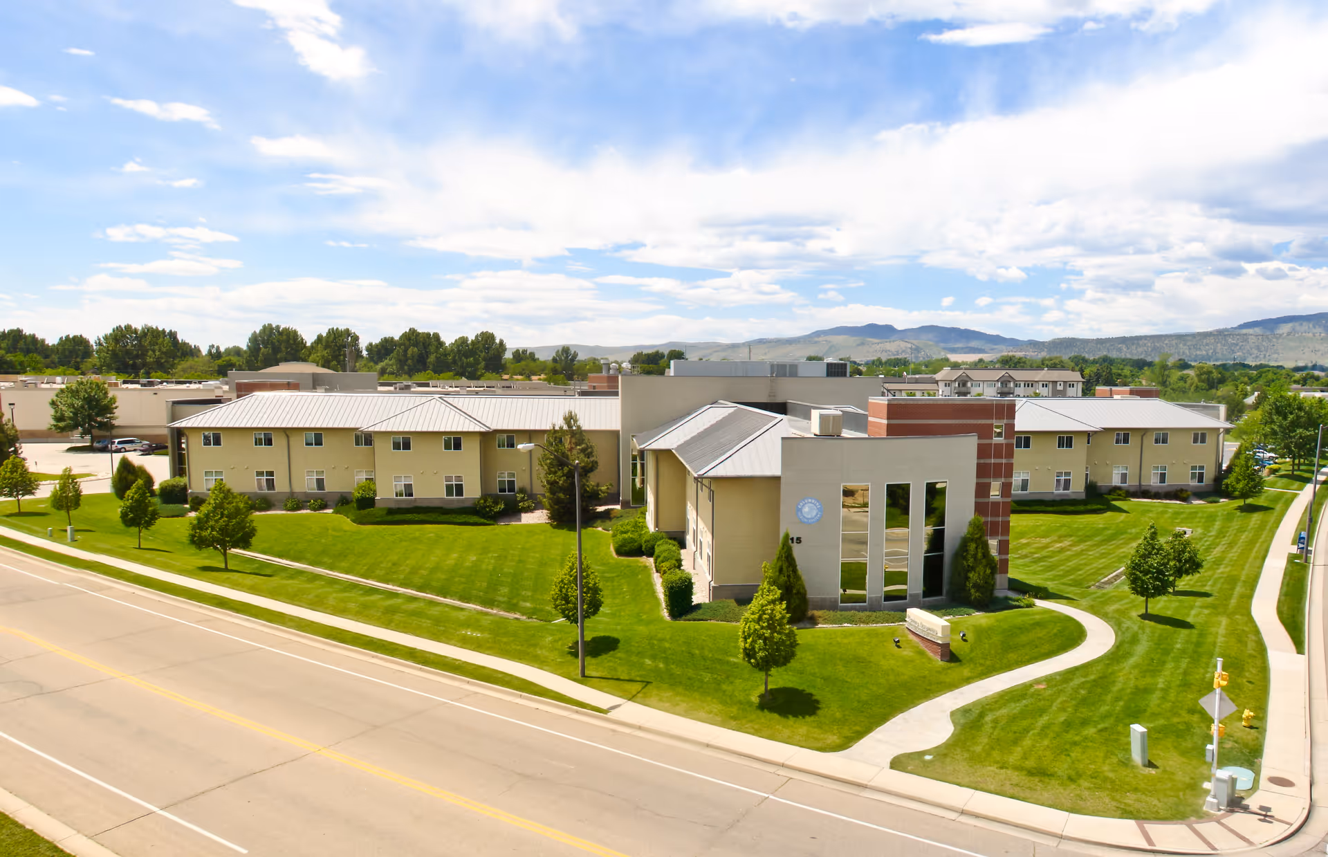 Aerial view of Centre Ave Health & Rehab campus with green lawns and modern building.