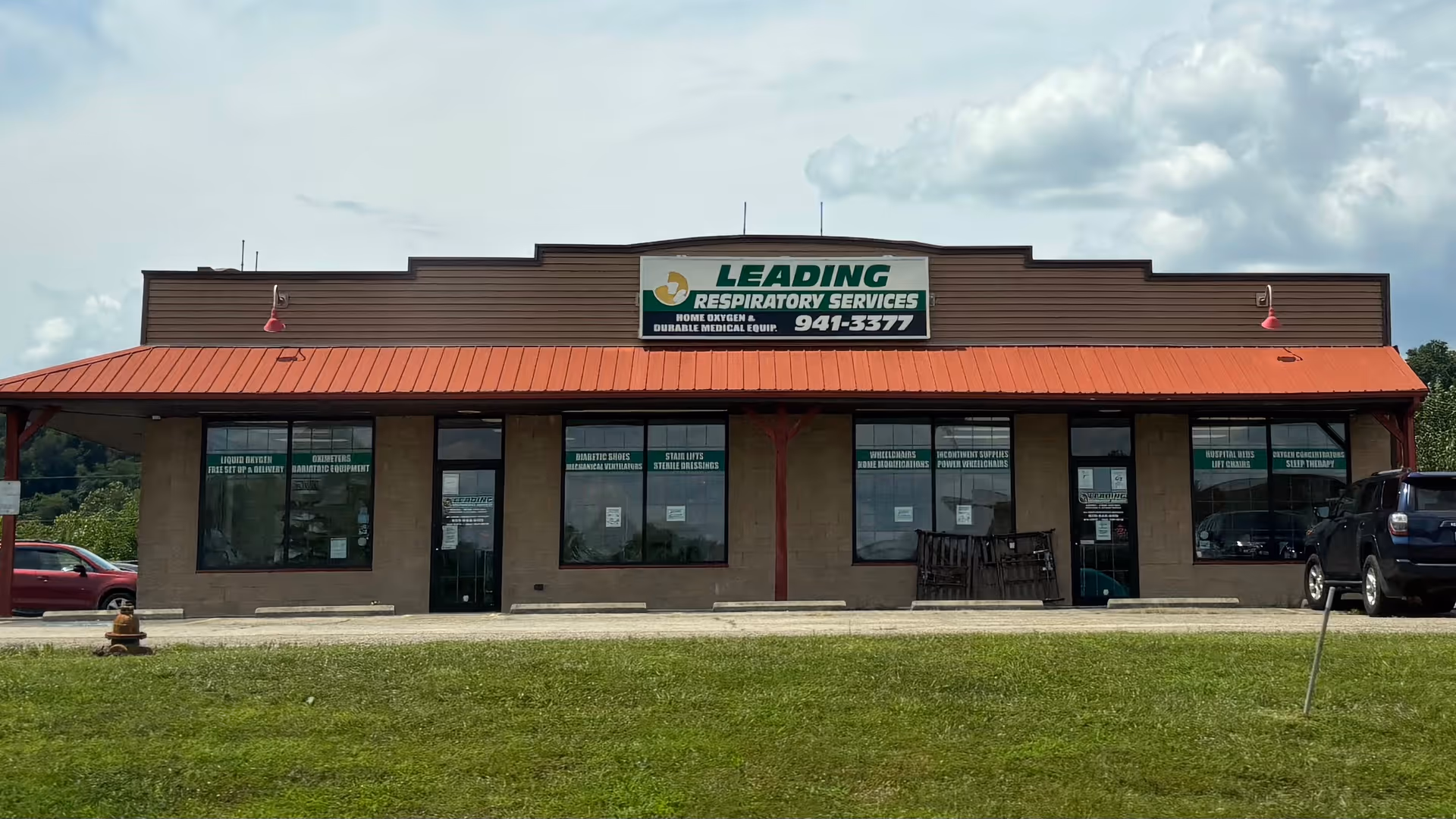 Single-story building with a red awning and a sign reading Leading Respiratory Services.