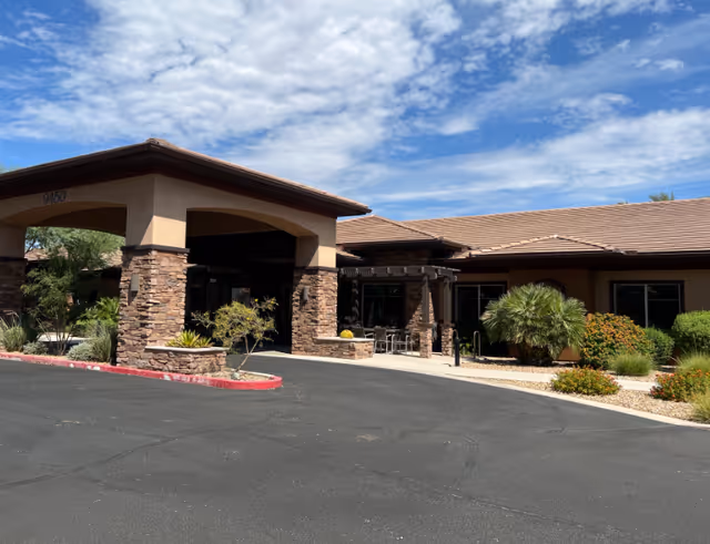 Exterior view of Golden Hearts Inc facility with a covered entrance and landscaped surroundings.