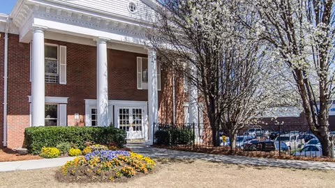 Front view of Decatur Center for Nursing and Healing, brick building with white columns.