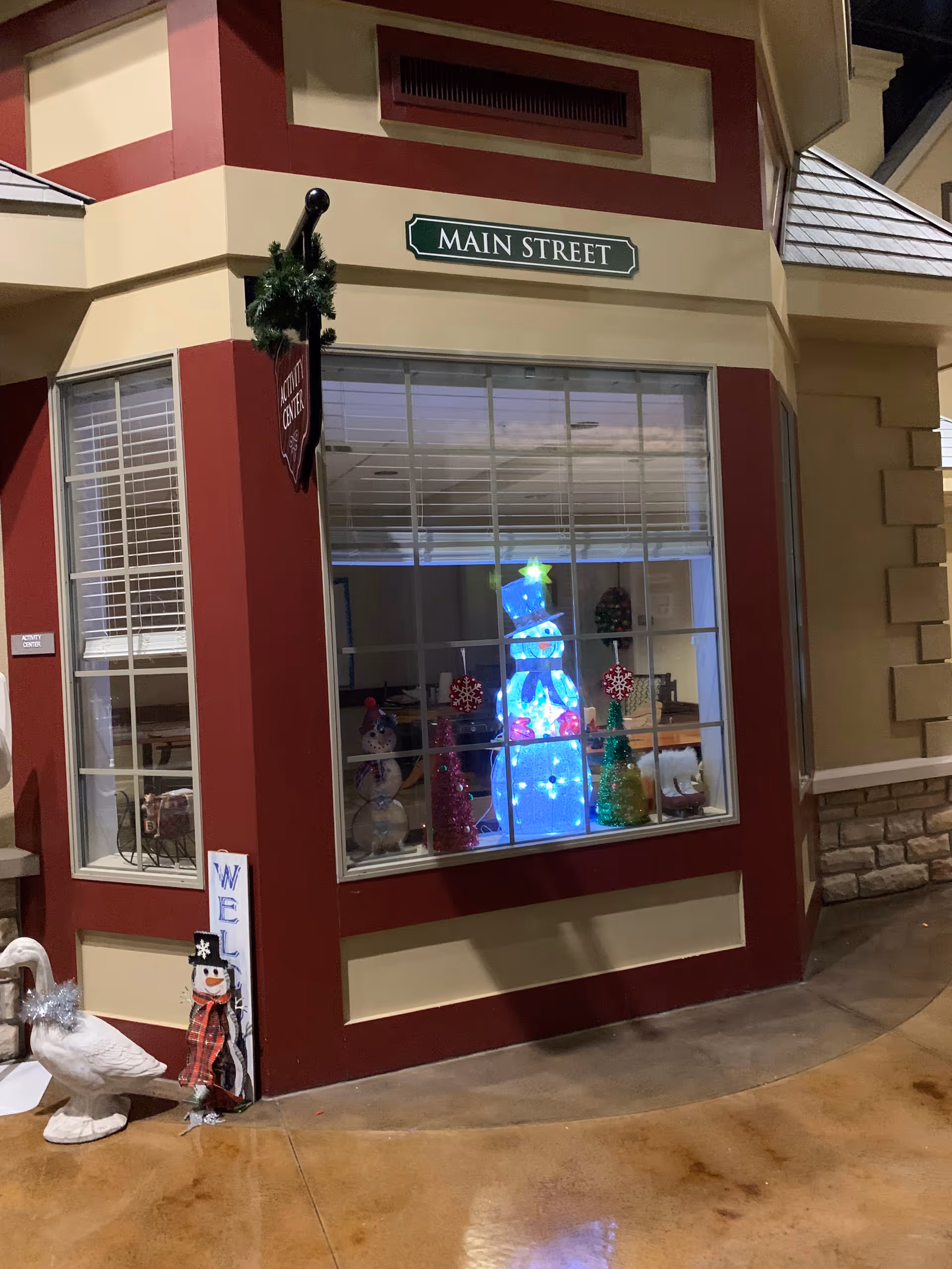 Exterior building corner with Main Street sign and holiday window display.