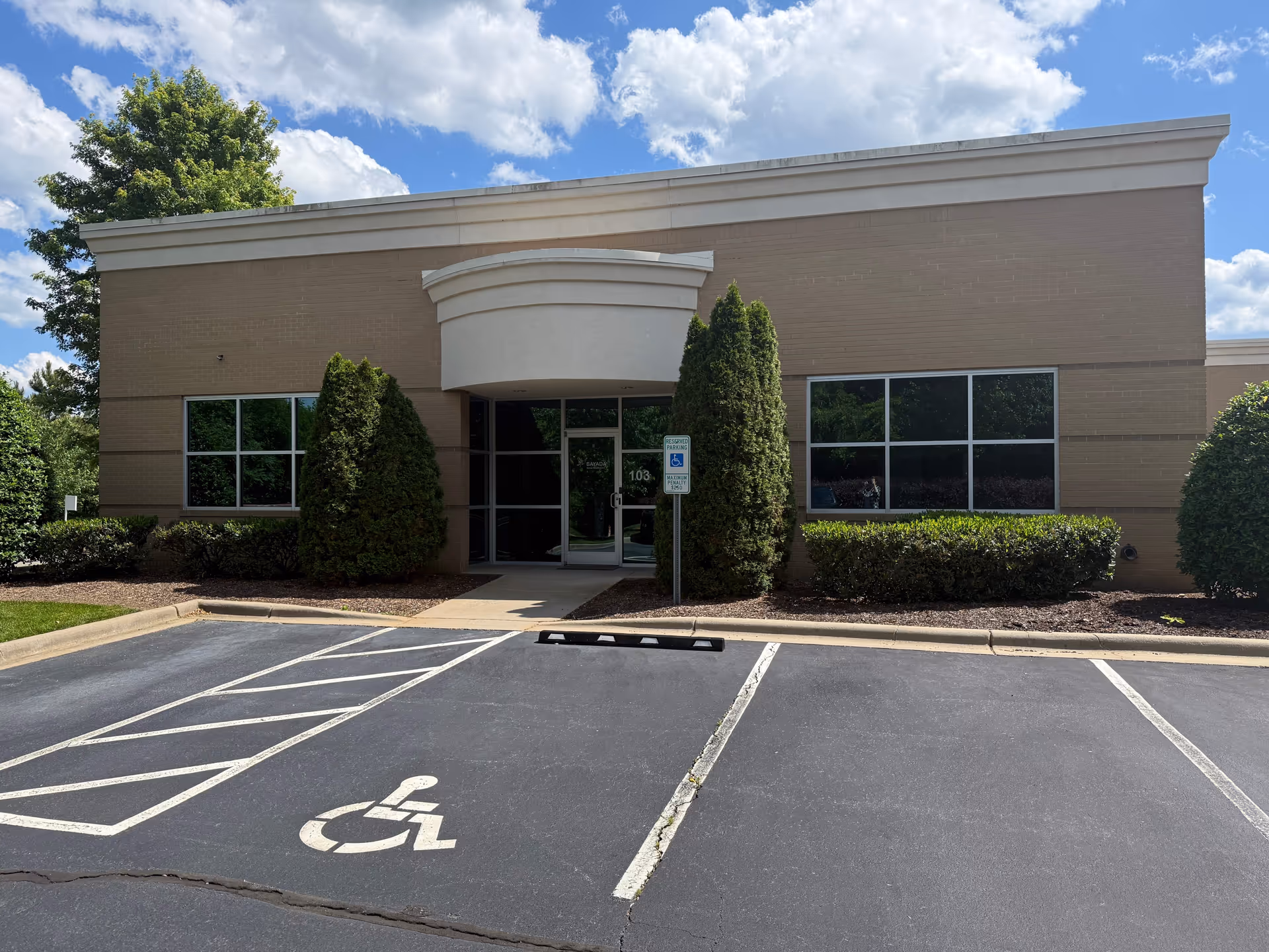Front view of BAYADA Home Health building with handicap parking and landscaped entrance.