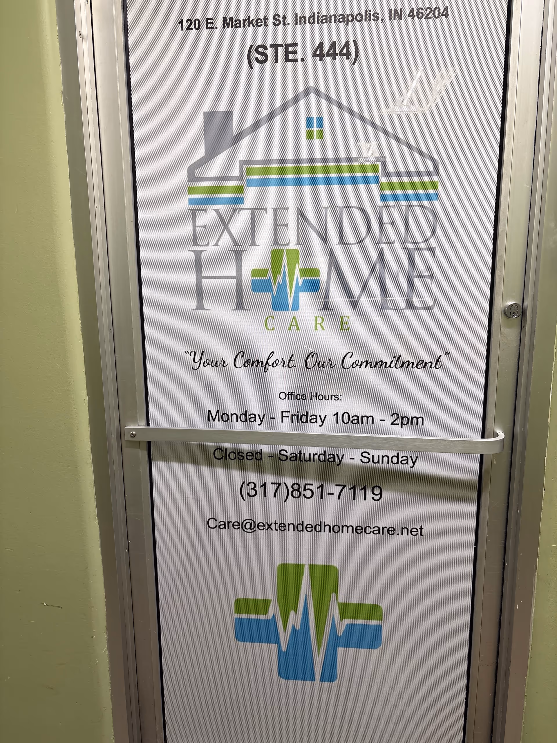 Door with Extended Home Care sign, logo and office hours displayed.