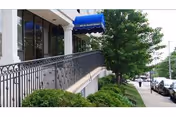 Exterior view of Regency Healthcare and Rehab Center with blue awning and greenery.
