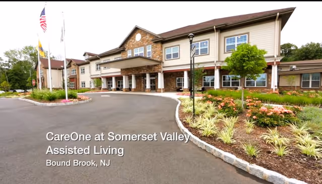 Front exterior of CareOne at Somerset Valley Assisted Living facility with landscaped driveway and entrance.