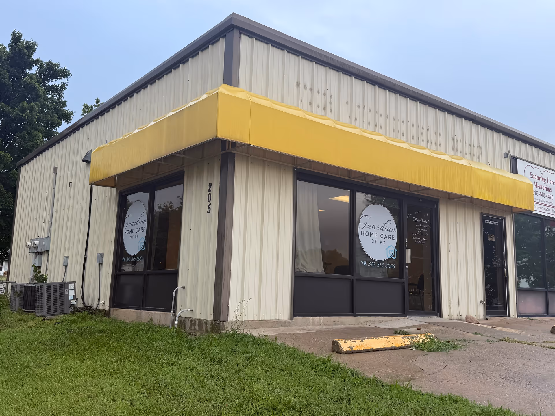 Exterior view of Guardian Home Care of KS storefront with a yellow awning.