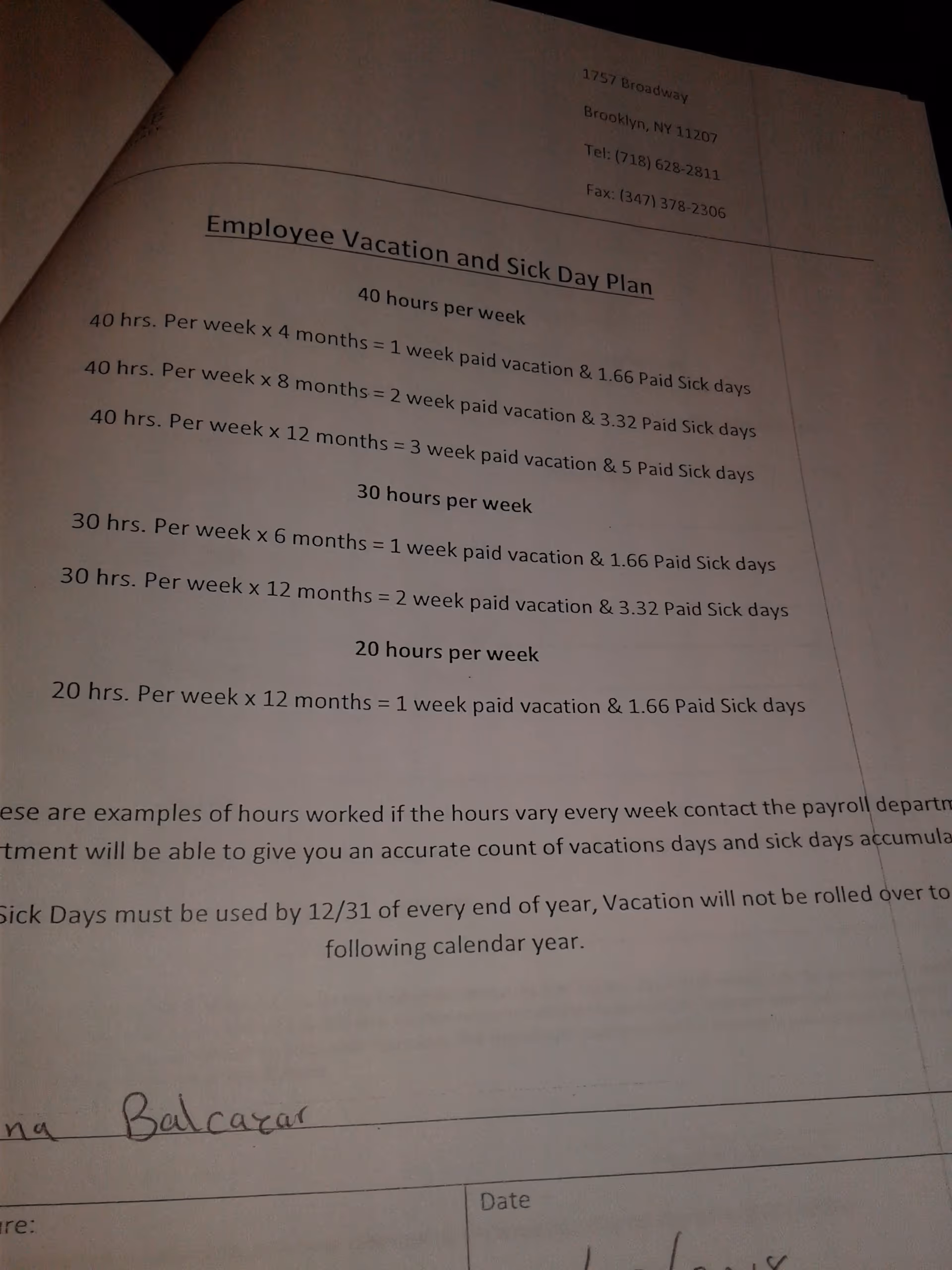Printed document titled Employee Vacation and Sick Day Plan on a desk.
