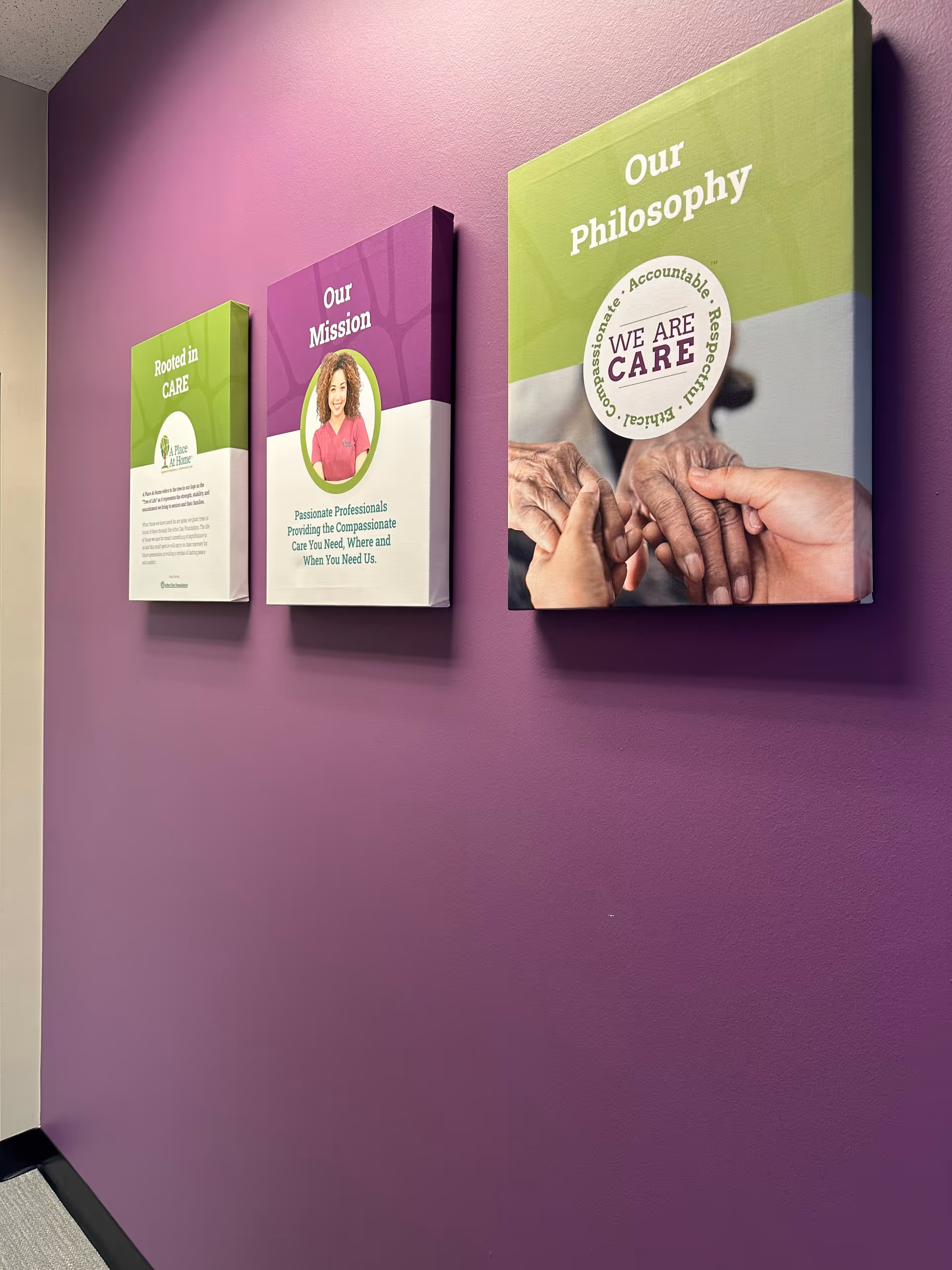 Purple hallway wall displaying three mounted panels titled Our Philosophy and Our Mission.