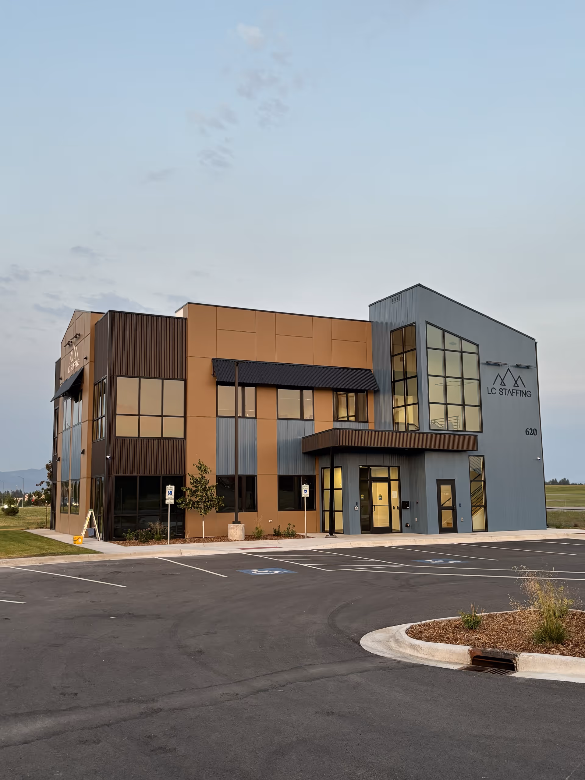 Loyal Care In-Home Assistance building exterior with modern blue-gray facade and parking.
