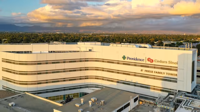Large white curved building exterior with Providence and Cedars-Sinai branding.