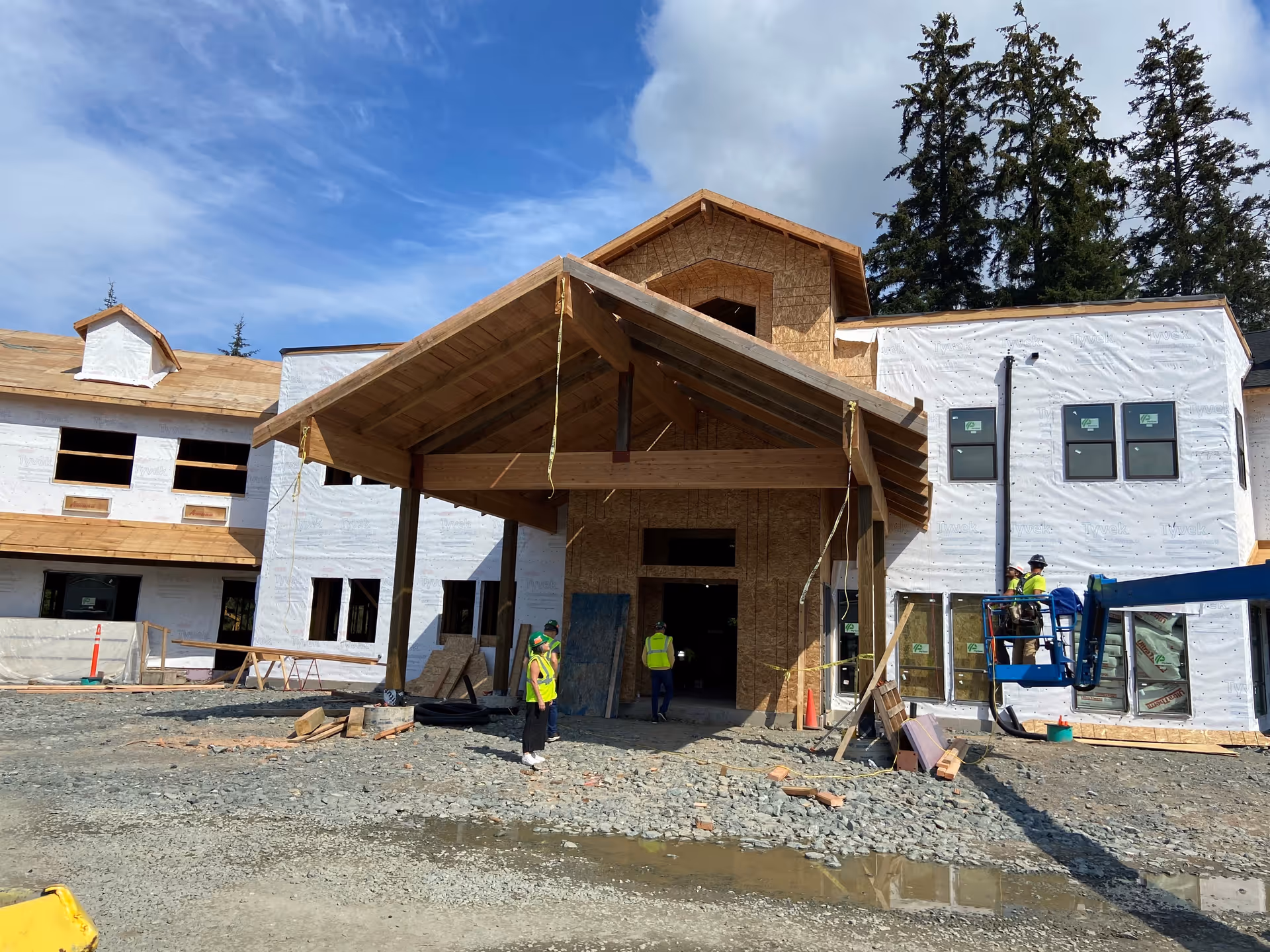 Riverview Senior Living building under construction with workers and wooden framing