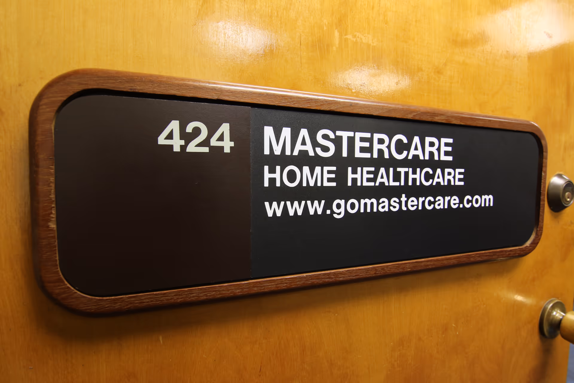 Door sign reading 424 Mastercare Home Healthcare on wooden plaque