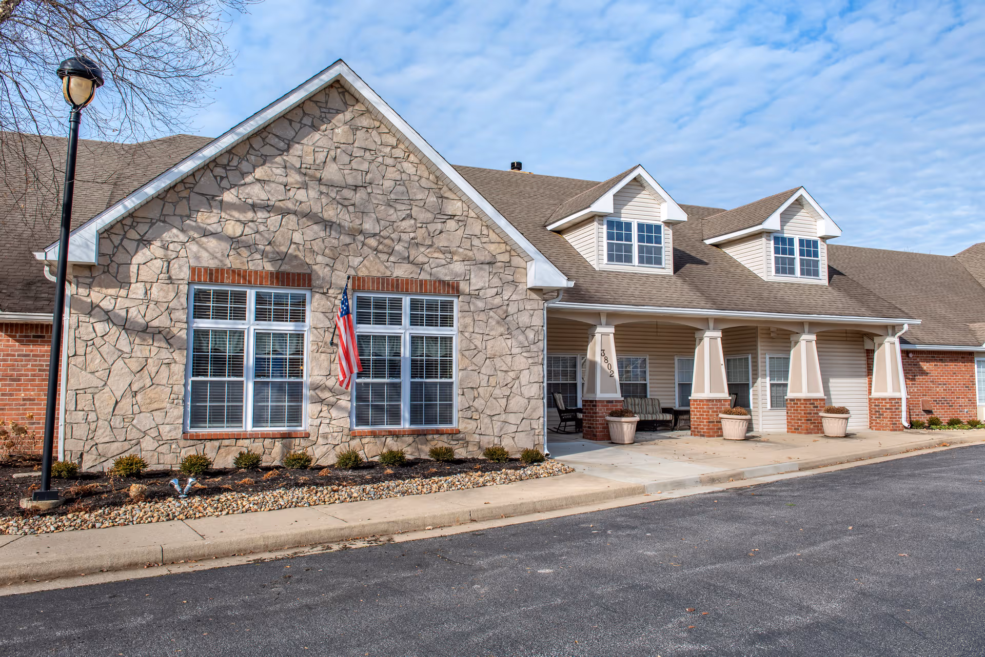 Front exterior view of Commons at Jackson Creek with stone facade and covered entrance.