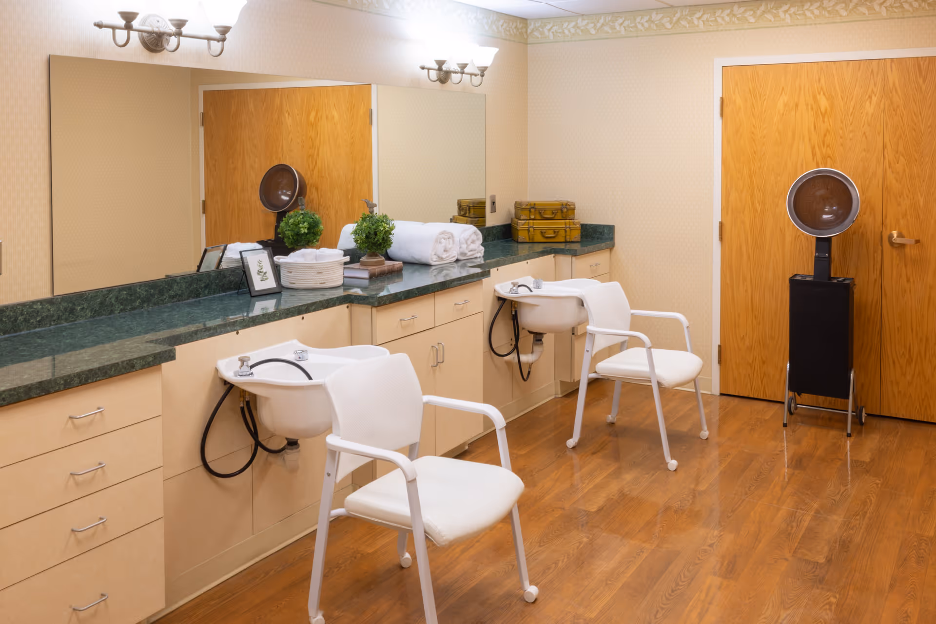 Salon area in a Legacy Marion senior living facility with sinks, mirrors, and chairs.