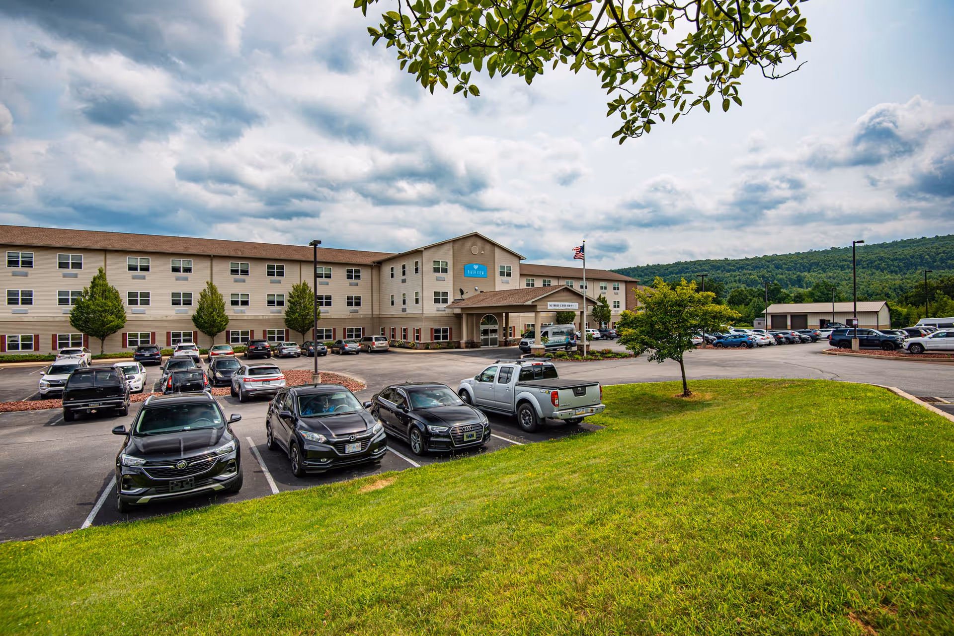 Exterior view of Timber Ridge Health Center with a parking lot and grassy lawn.