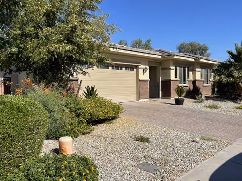 Exterior view of Destiny Care Home, a single-story facility with a two-car garage and desert landscaping.