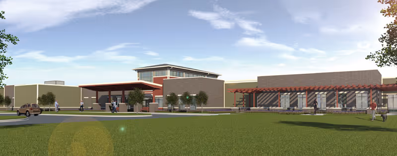 Wellbrooke of Kokomo exterior: modern building with entrance canopy and lawn.