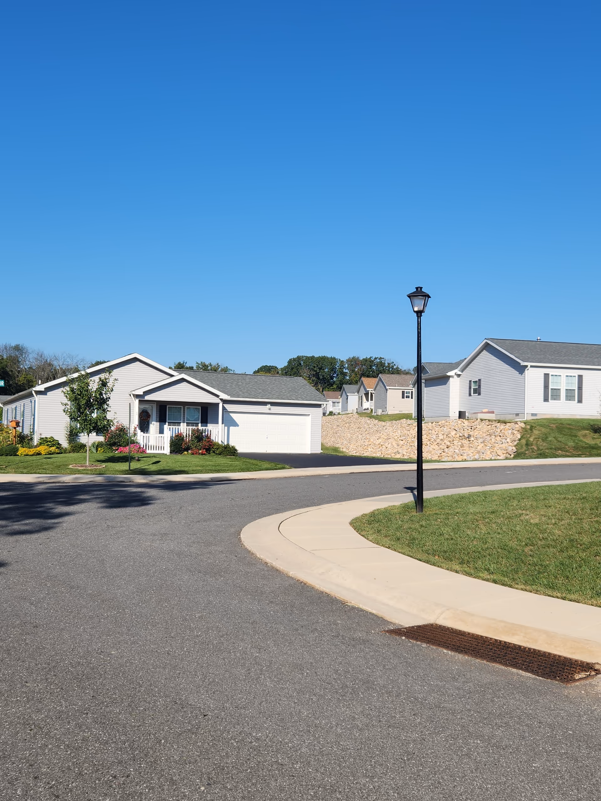 Quiet exterior of a senior living campus with single-story homes and a lamppost