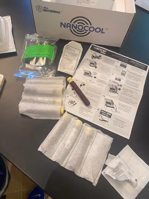 Medical supplies on a black countertop with a Nanocool box and instruction sheets.