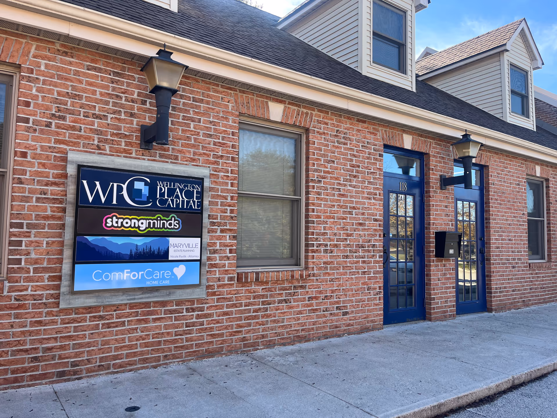 Brick building exterior with blue doors and signage for ComForCare Maryville