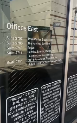 Glass door displays 'Offices East' with suite numbers and a reflected exterior.