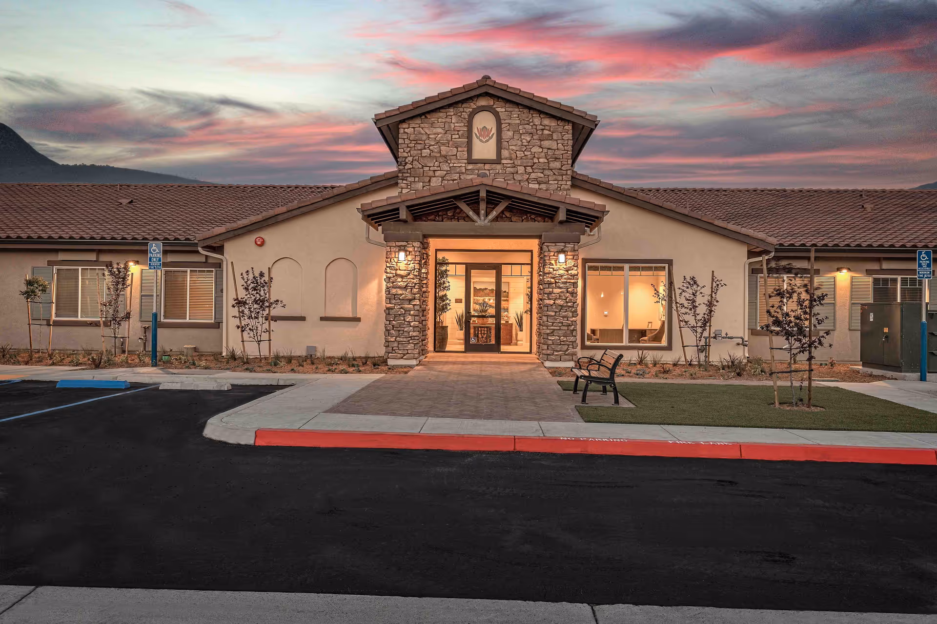 Front view of Vineyard Ranch at Temecula entrance with stone facade and sunset sky.