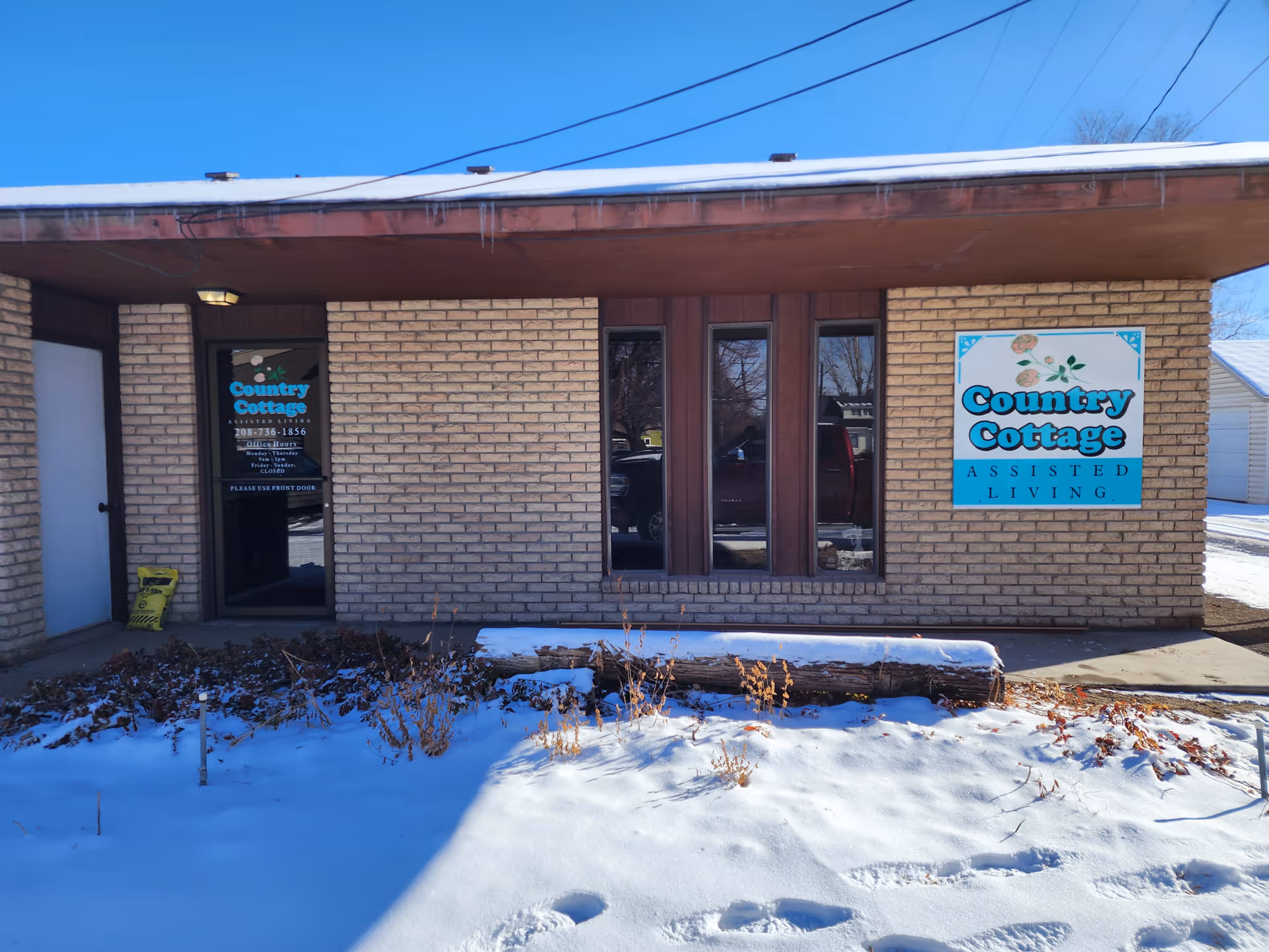 Front view of Country Cottage Assisted Living facility with brick exterior and signage.