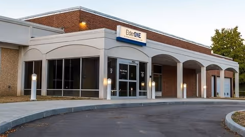 Exterior view of ElderONE North Park PACE Center entrance with curved arches.