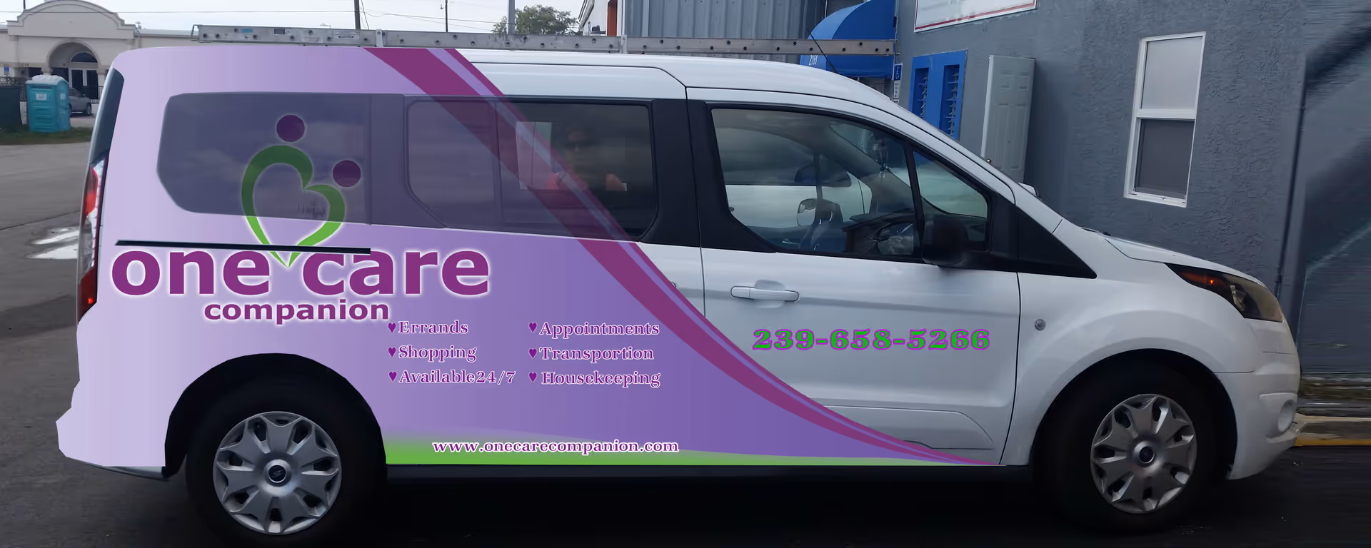 White van with purple graphics advertising One Care Companion, Inc.