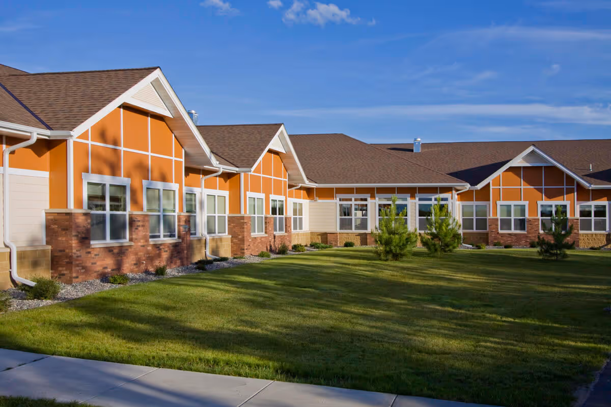 Exterior view of Sanford Health Neilson Place building with orange panels and manicured lawn.