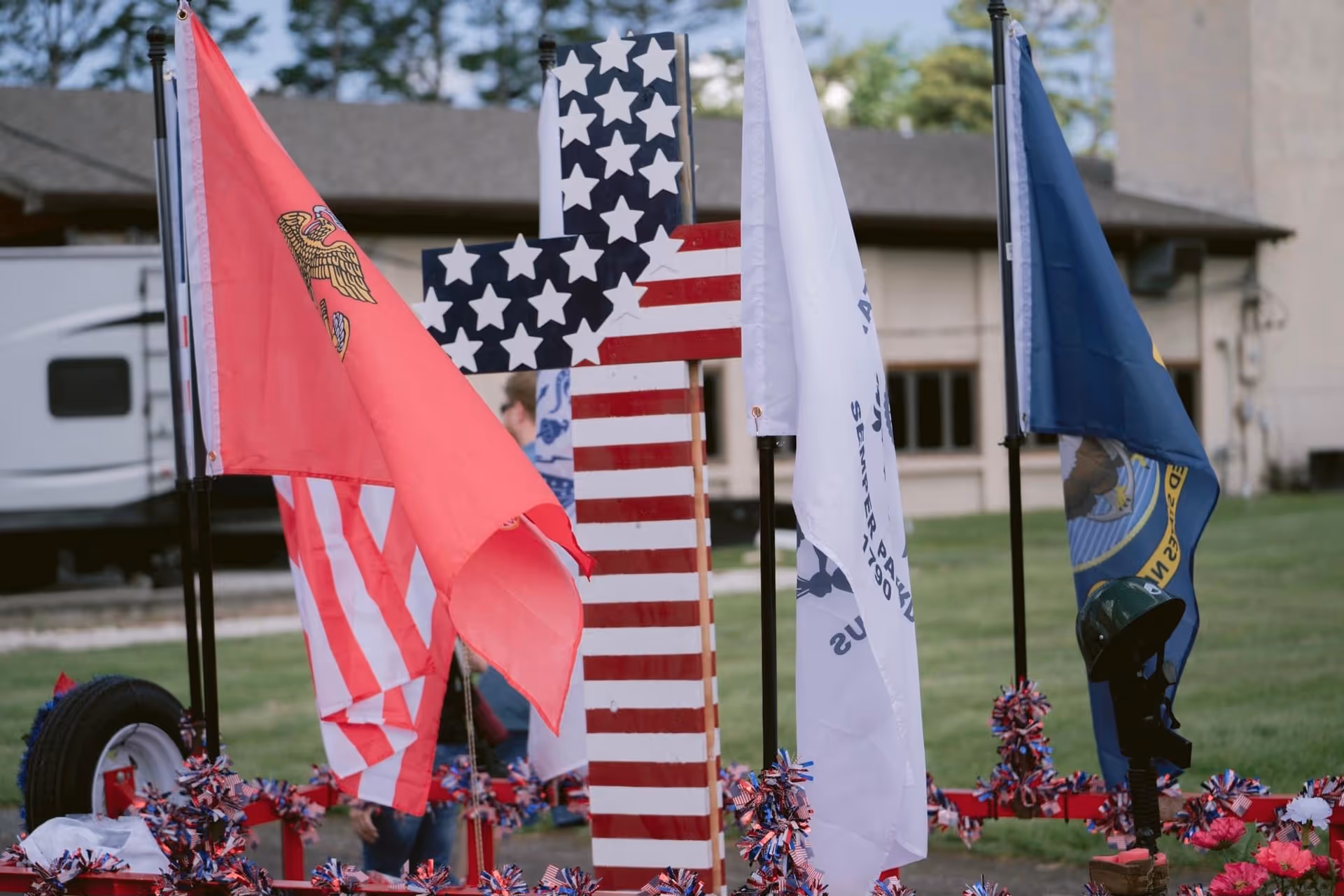 Flags representing countries and organizations line the lawn in front of Heart and Home Care, LLC.
