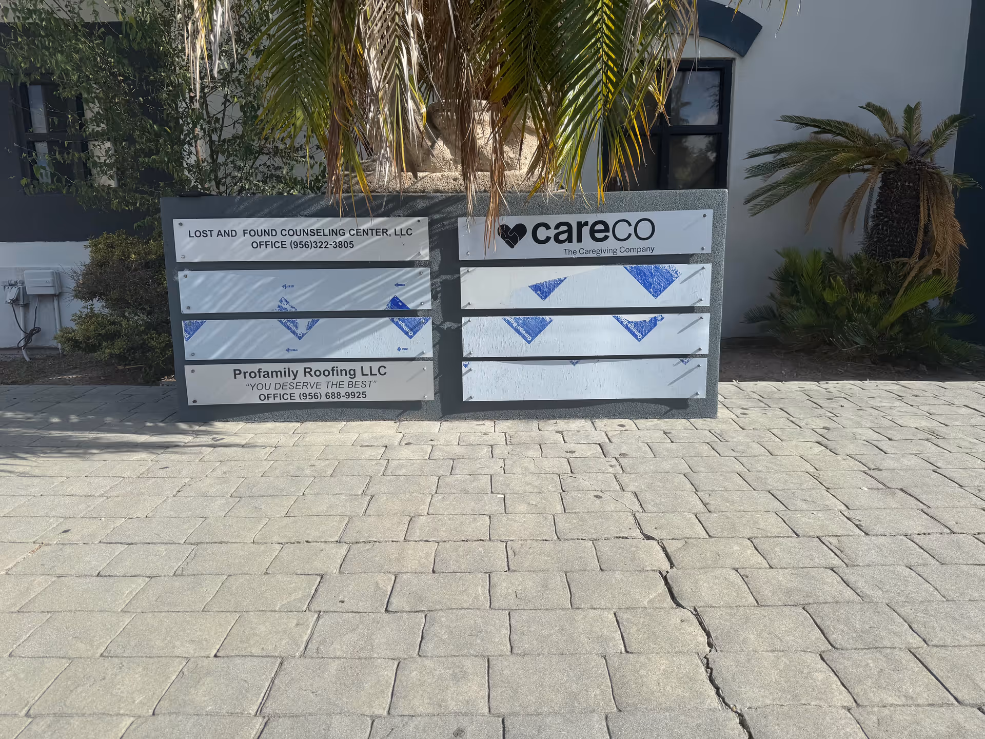 Exterior view of a building front with CareCo sign and multiple business panels.