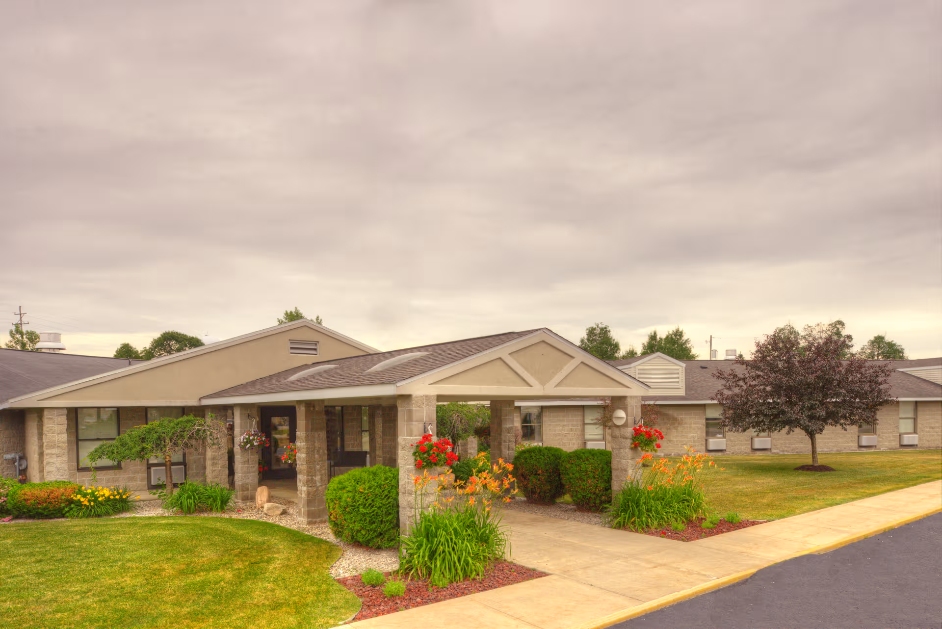 Grayling Nursing & Rehab Community exterior with covered entrance and well-kept landscaping.
