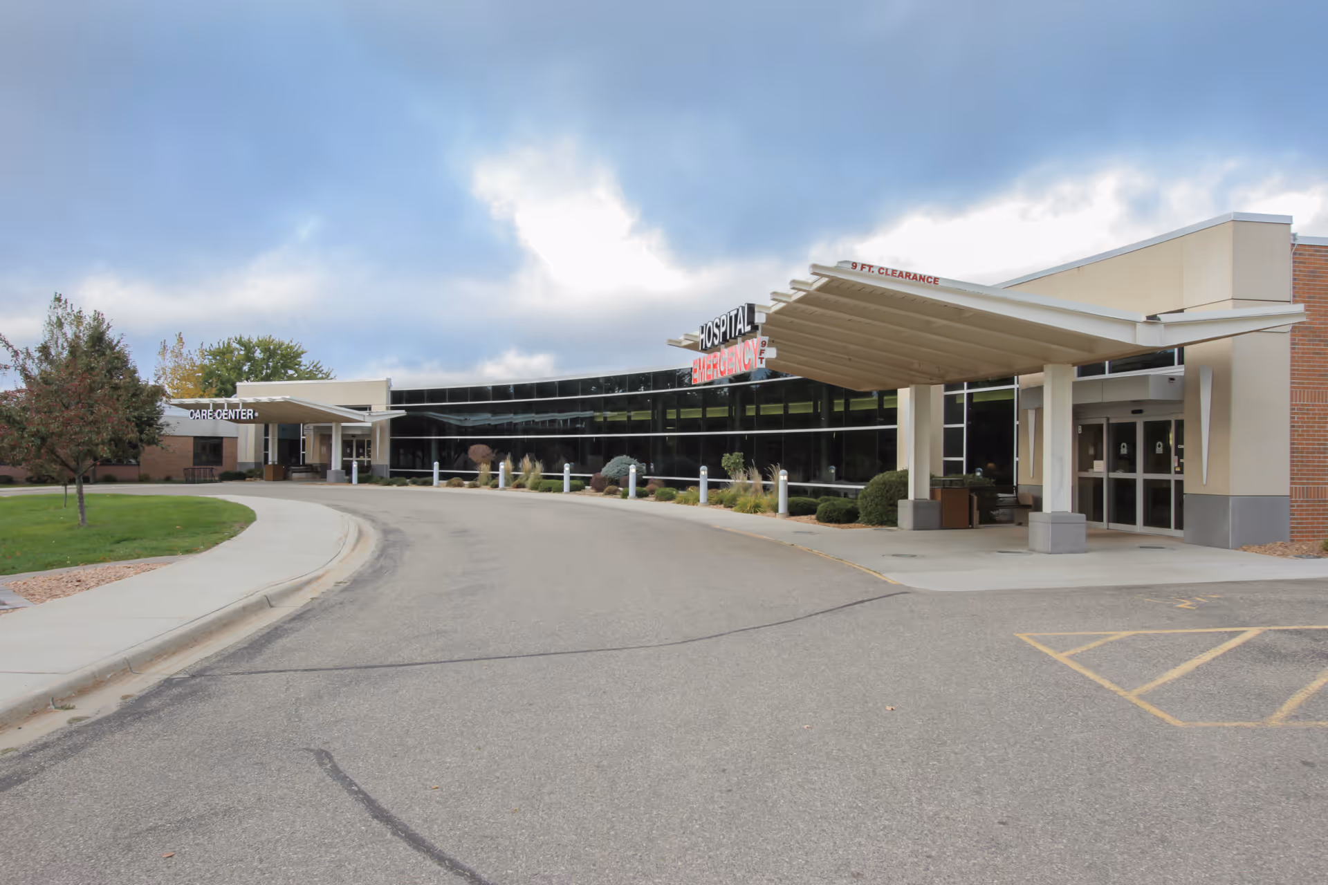 Exterior view of Centracare Health System Sauk Centre Nursing Home entrance with canopies and driveway
