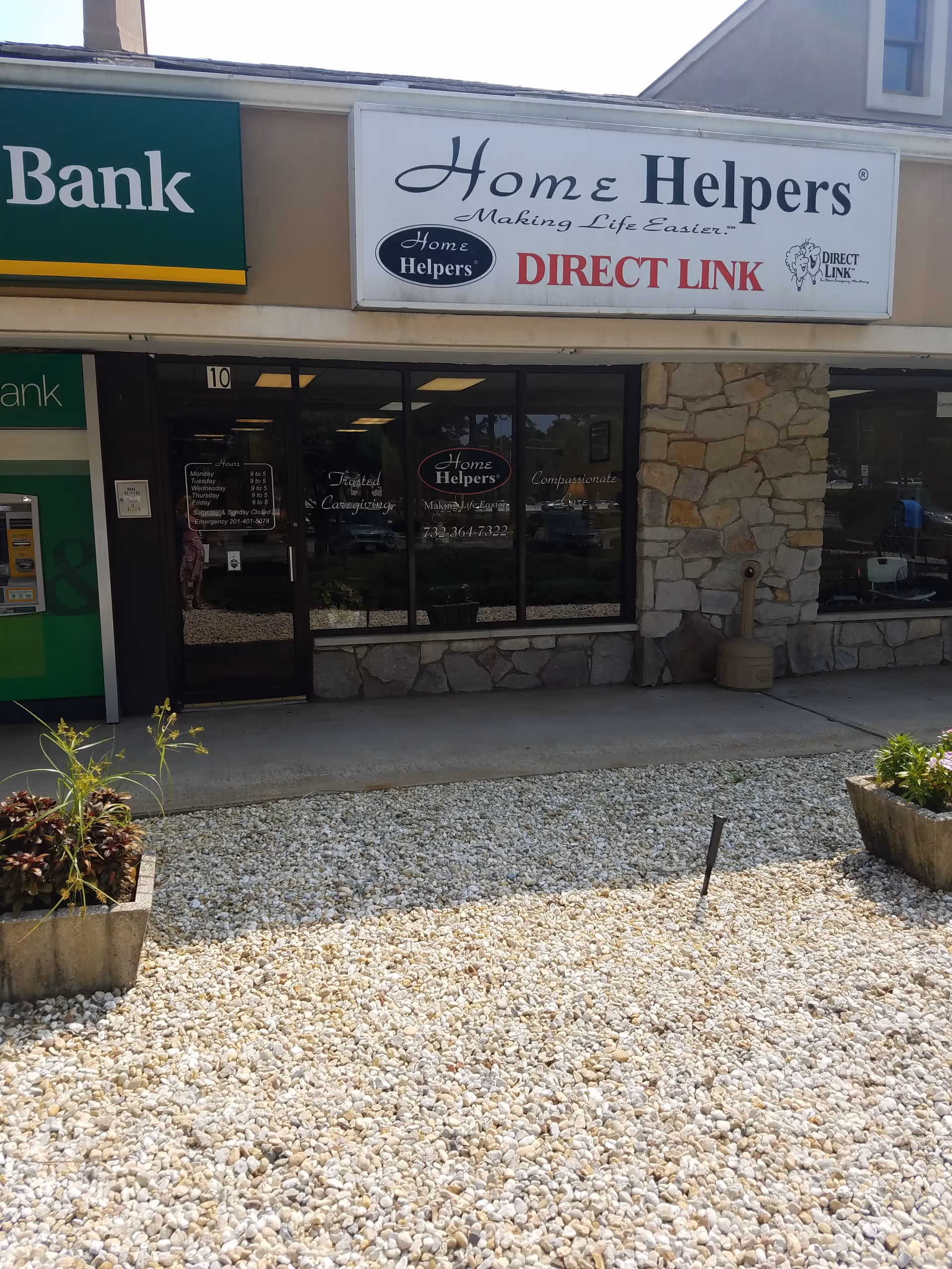 The Home Helpers Direct Link storefront features glass doors and a stone facade.