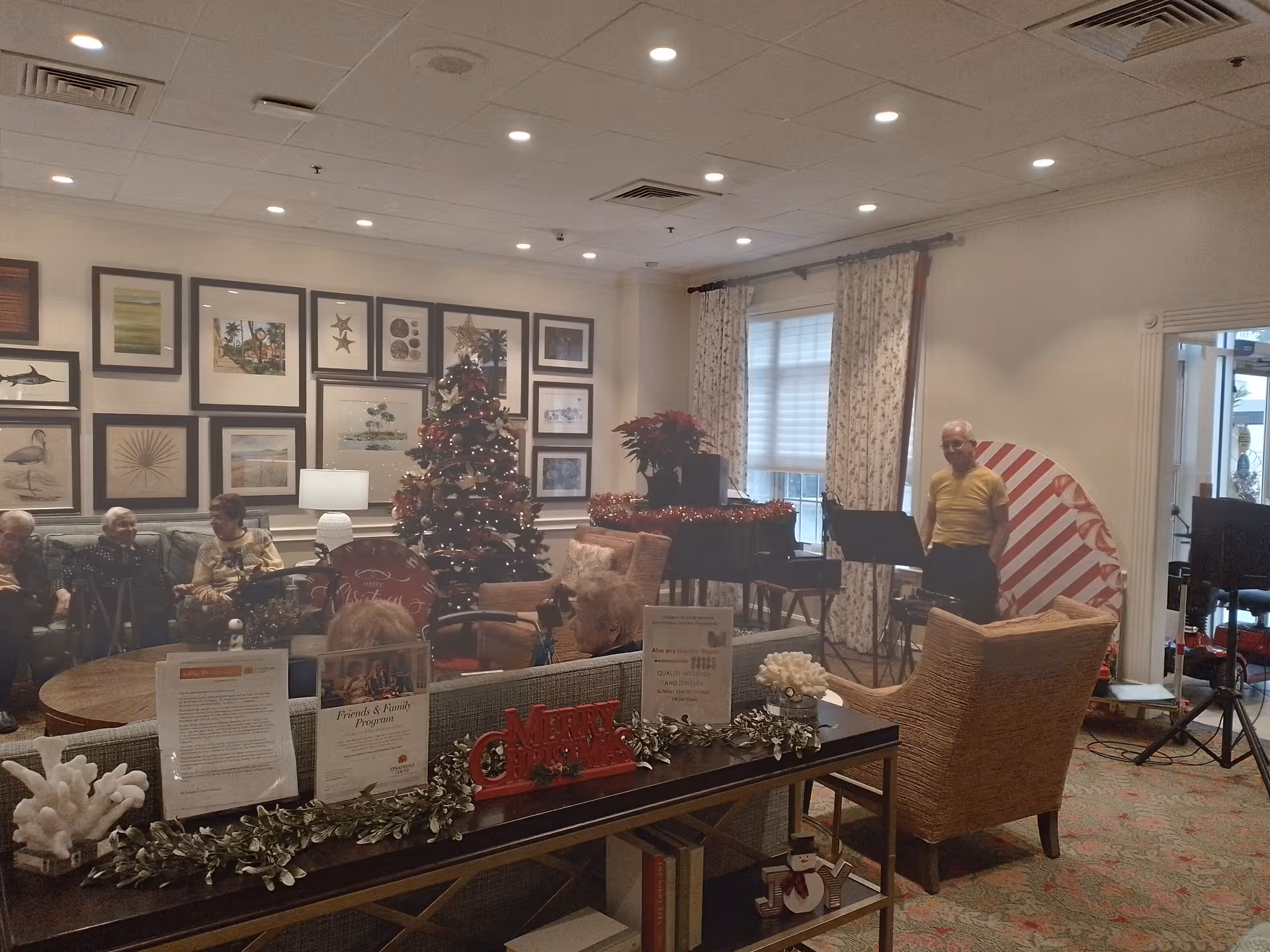 Common area of Stratford Court of Boca Pointe with Christmas tree and residents.