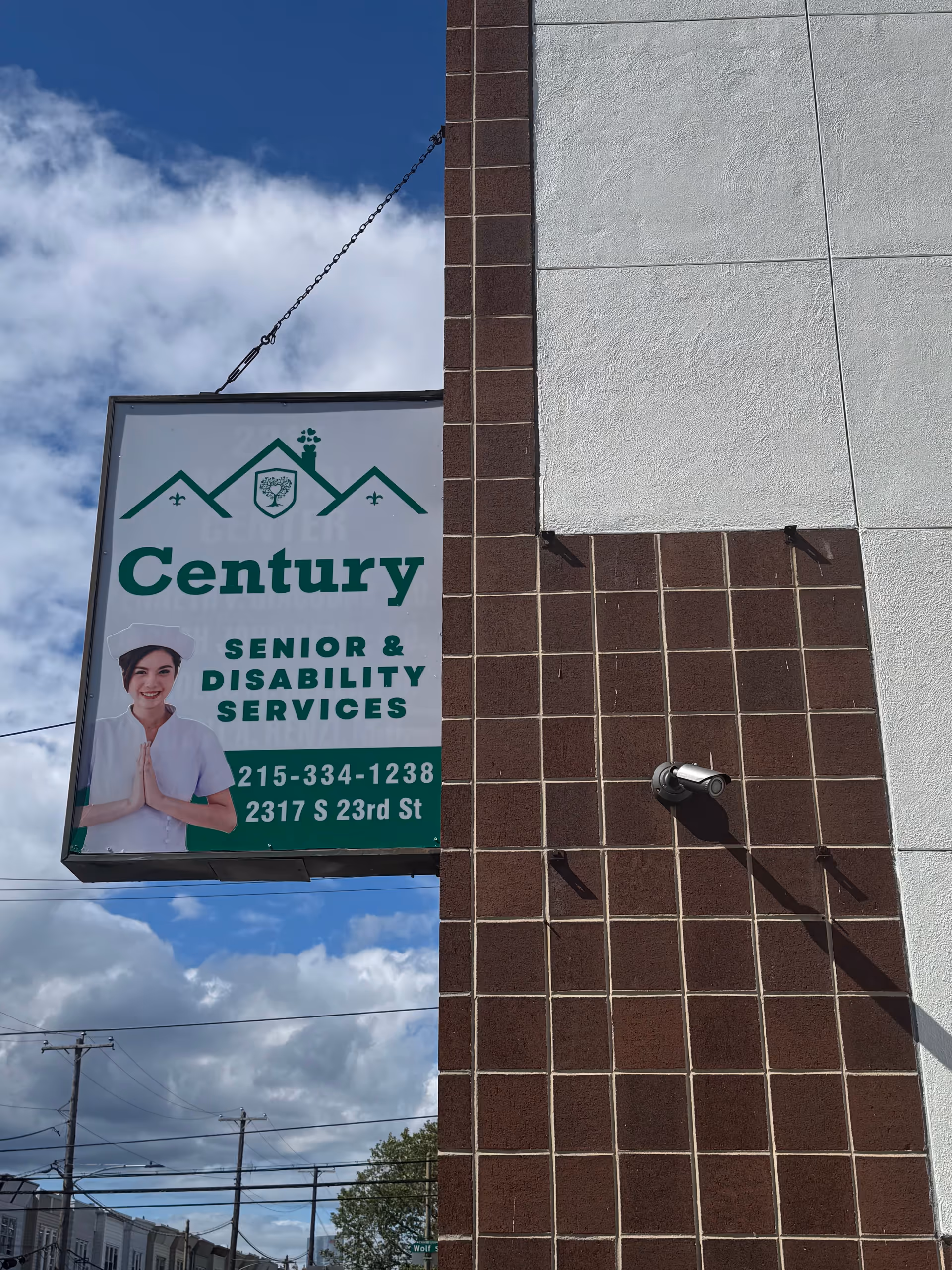 Exterior sign for Century Senior & Disability Services on a brick building.