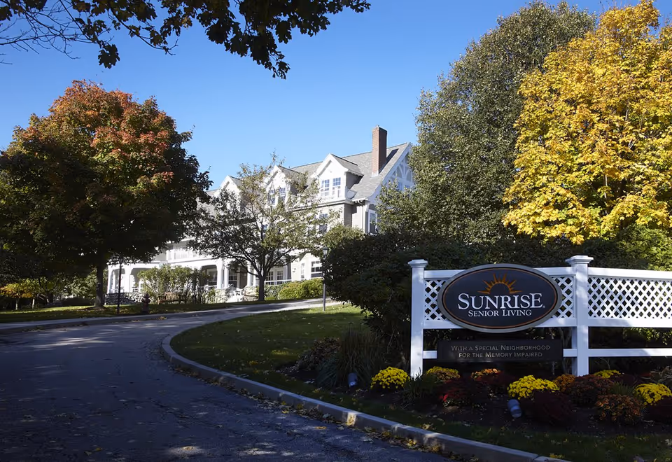 Sunrise Senior Living building seen from the curved driveway with a large front sign.