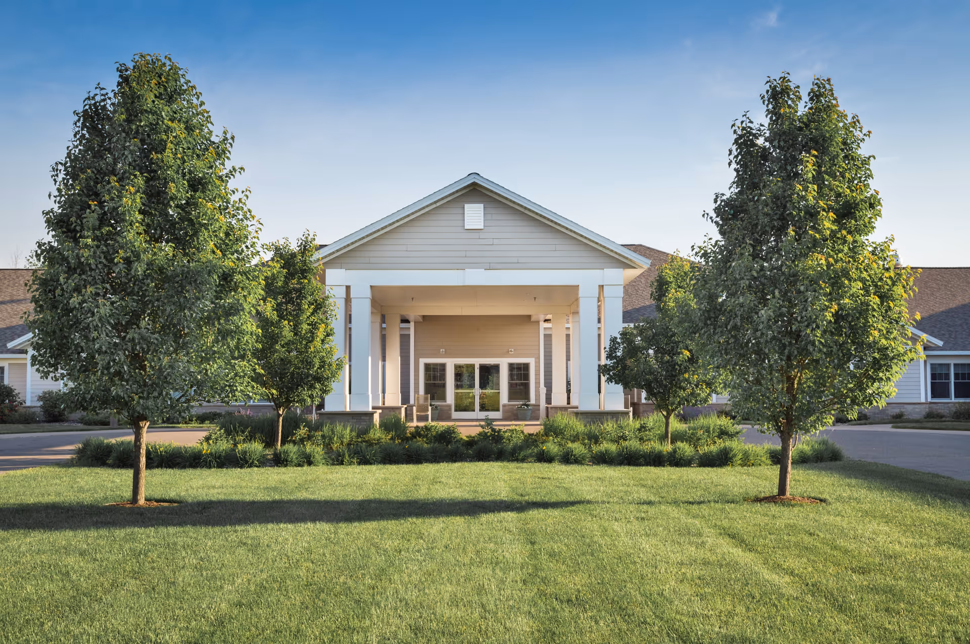 Exterior view of Brookdale Bonita Springs building front with lawn and trees