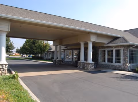 Front exterior of Brookdale Kettleman Lane with a covered entrance and stone pillars.